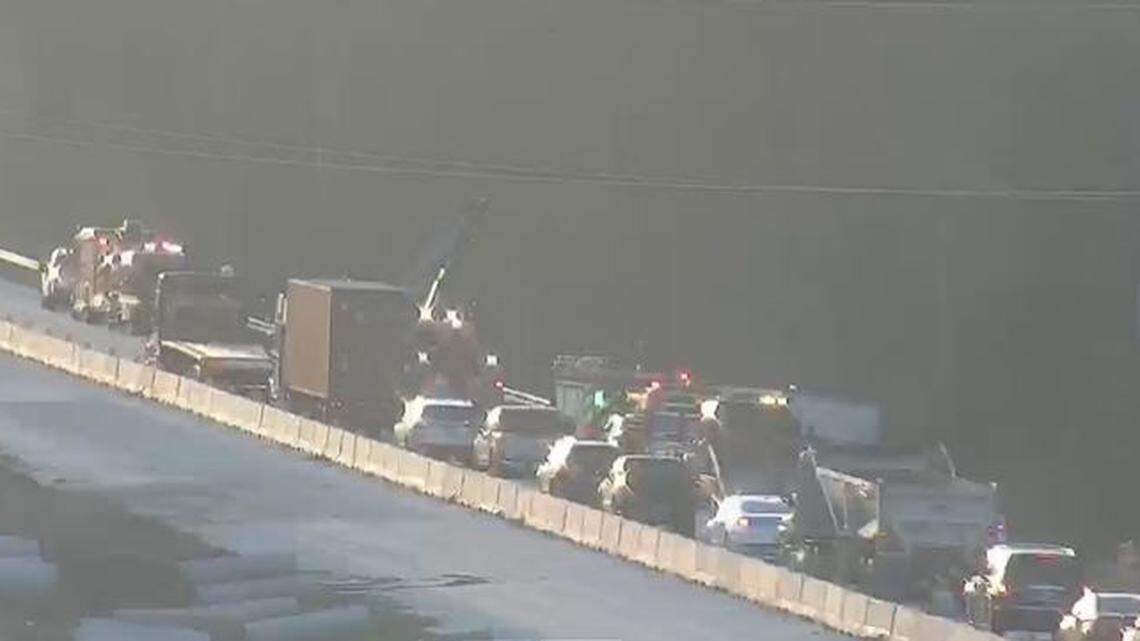 Vehicles were backed up on an interstate after a crash and hazardous material spill.