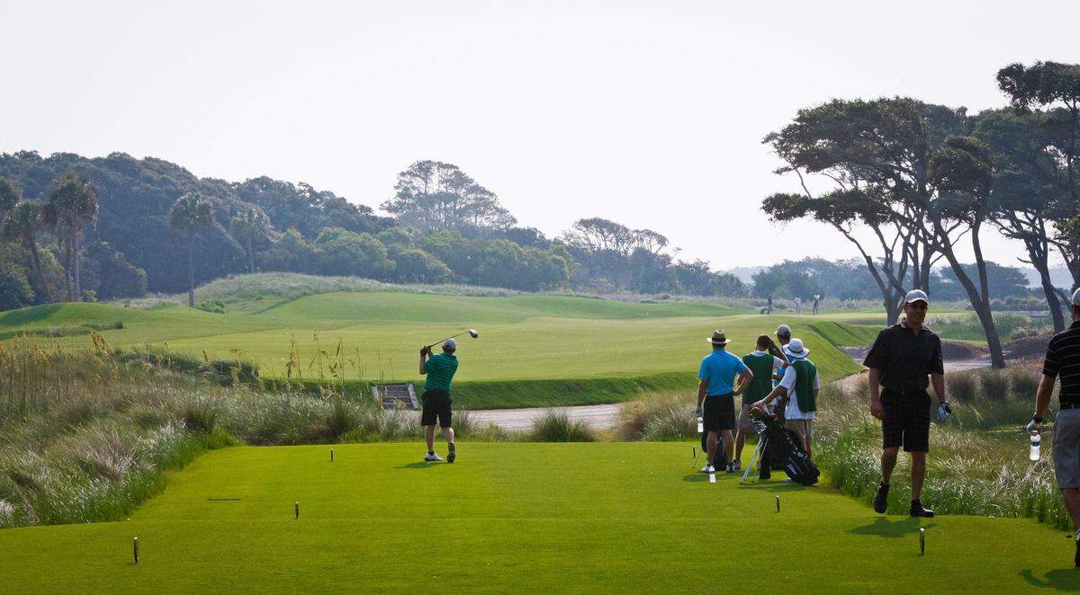 The Ocean Course has been called one of the toughest and one of the most beautiful courses in the world. Toughest because the wind always blows and there is lots of trouble (water, sand, etc). Beautiful because of the ocean views. Here, the porch overlooking the Atlantic Ocean. The Ocean Course at Kiawah Island Golf Resort opens with a relatively short par-4, giving the player an opportunity to get their round off to a good start. This may be the narrowest fairway on the course. Still, there is plenty of room between the waste bunker that guards the right side of the fairway from tee to green and the thick dune grass that borders the left. A good drive will leave a short iron to a gently undulating green tucked into a natural dune area with a generous opening from the left. A pond stretches halfway down the right side, but doesnaÉ¬¢a¢,Äö¬¨a¢,Äû¬¢t come into play.