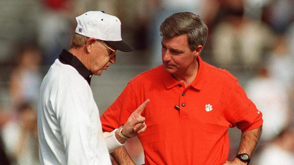 South Carolina's Lou Holtz and Clemson's Tommy Bowden chat before the start of their game Nov. 20, 1999.