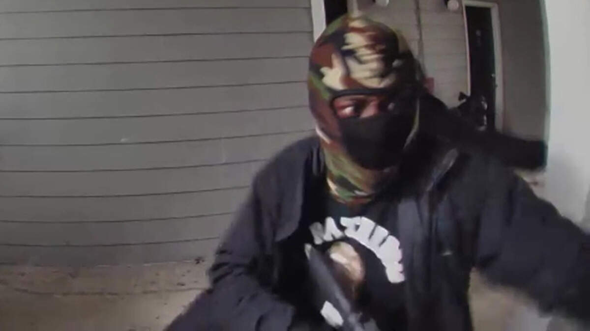Surveillance footage screen grab of a person wanted for their involvement in a shooting.