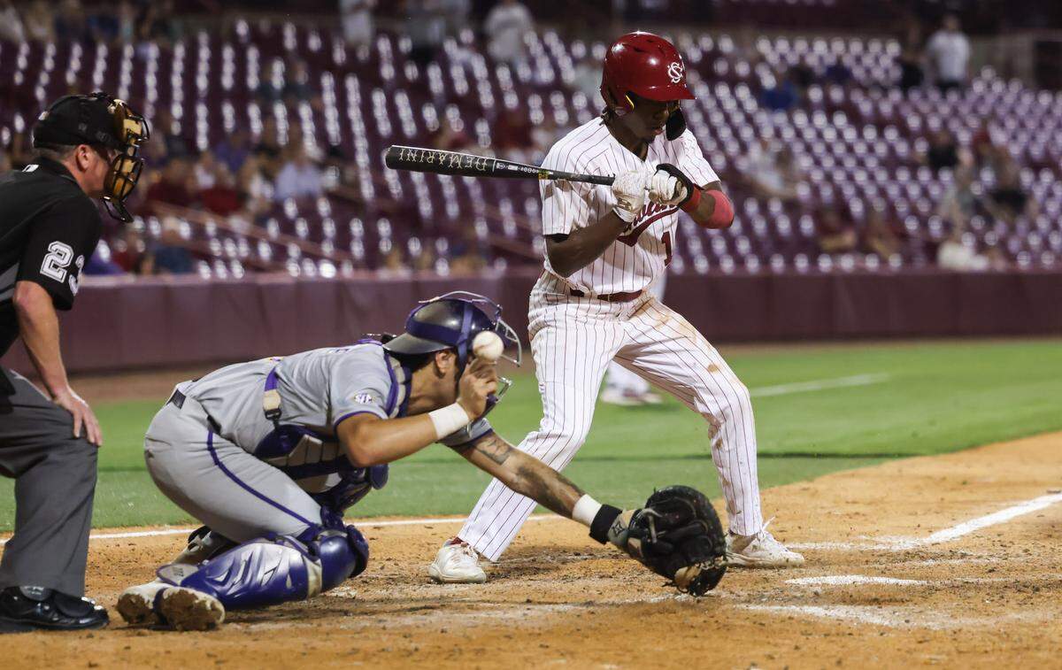 South Carolina infielder Cayden Gaskin (11) stands at the bag as a wild pitch gets by LSU catcher Cade Arrambide (0) during the Gamecocks’ game against LSU at Founders Park in Columbia on Thursday, May 15, 2025. South Carolina outfielder Dalton Mashore (3) scored the winning run of the game on the play.
