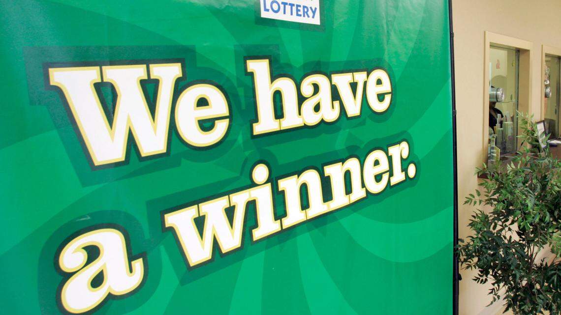 The man plans to visit the store in his new car, he told lottery officials. (AP Photo/Chuck Burton)