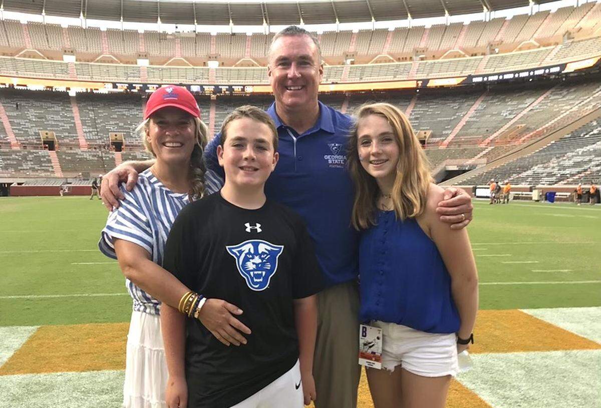 Shawn Elliott, his wife, Summer, and their kids, Maddyn and Max, huddled together for a picture on the field at Neyland Stadium following Georgia State’s win over Tennessee in 2019.