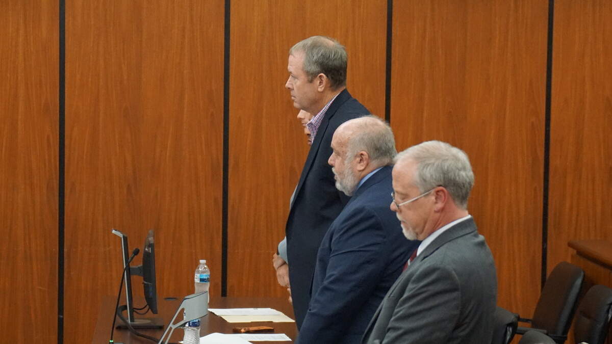 Russell Laffitte stands with his attorney Mark Moore (center) and Assistant Attorney General Creighton Waters (foreground) as the once prominent banker pleads guilty to eight state charges for his role in thefts committed by former-attorney and murderer Alex Murdaugh.