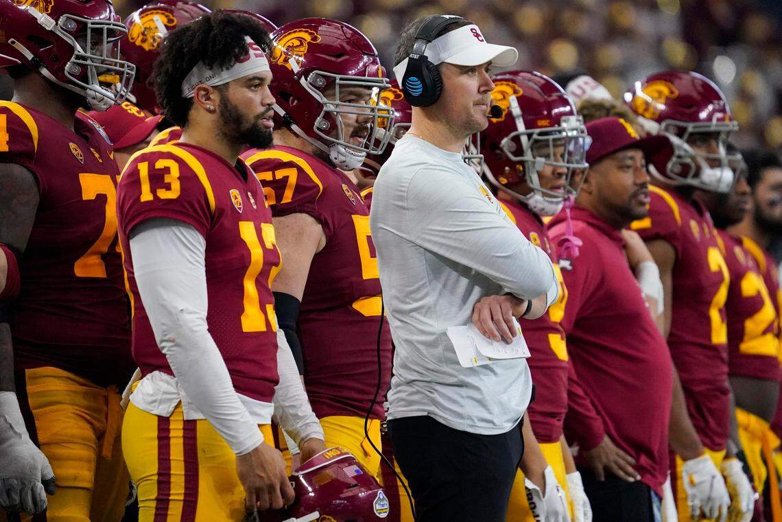 Southern California quarterback Caleb Williams (13) and head coach Lincoln Riley watch play during the first half of the Cotton Bowl NCAA college football game against Tulane, Monday, Jan. 2, 2023, in Arlington, Texas. (AP Photo/Sam Hodde)