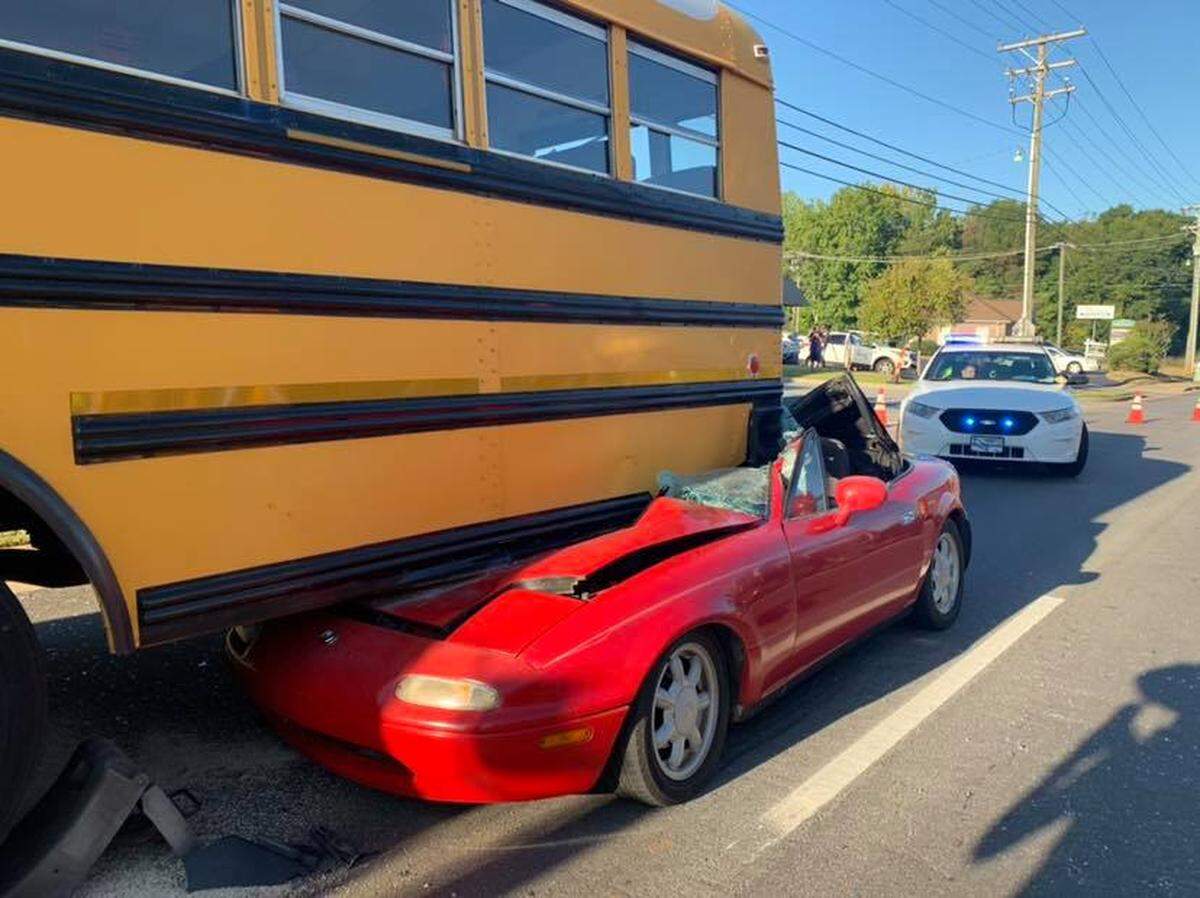 A convertible crashed into the back of a school bus Wednesday morning in Greenville, South Carolina, police said.
