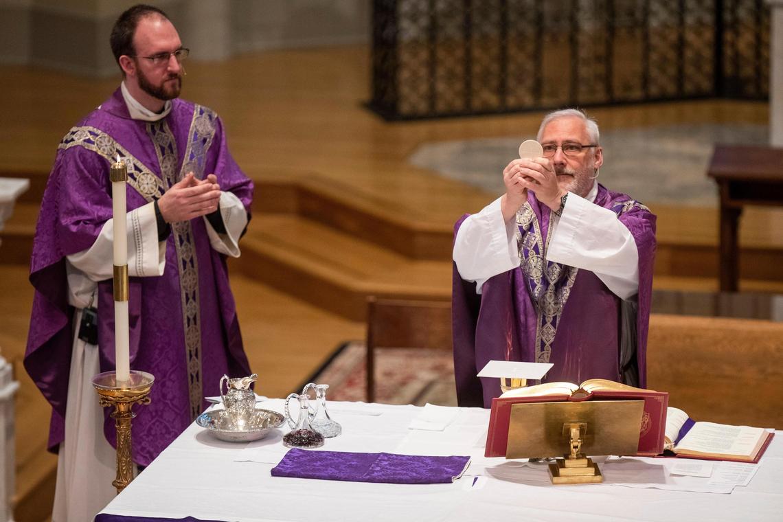 Father Gary Linsky prepares a wafer and wine for communion at St. Peter’s Basilica in downtown Columbia, South Carolina on Thursday, April 2, 2020. The staff in attendance were able to accept communion, and those watching from home were invited to make a prayer to accept it from afar.