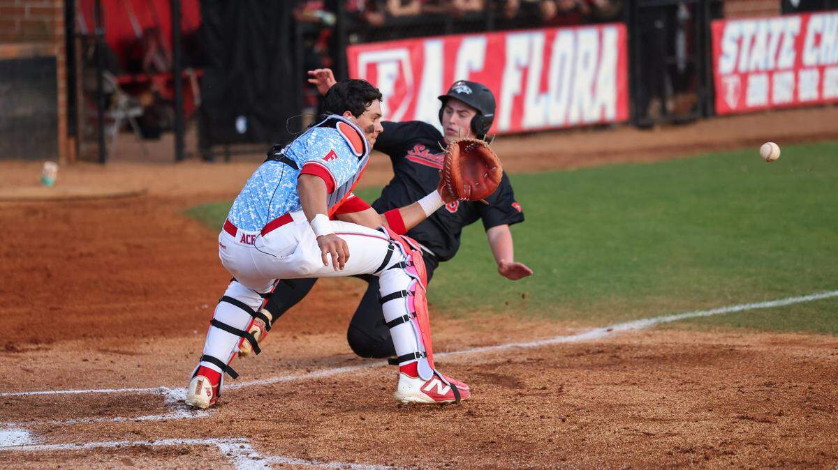 Dylan Hernandez (12) of AC Flora prepares to tag out Lance Whitaker (15) of South Pointe at home plate during AC Flora’s game against South Pointe in Columbia on Tuesday, March 31, 2026.