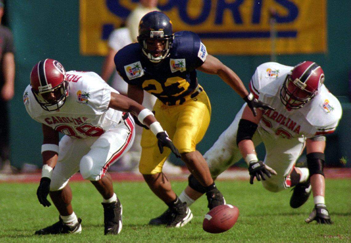 South Carolina’s Marcus Robinson and West Virginia’s Mike Logan go after a fumble in the Carquest Bowl on Jan. 2, 1995.