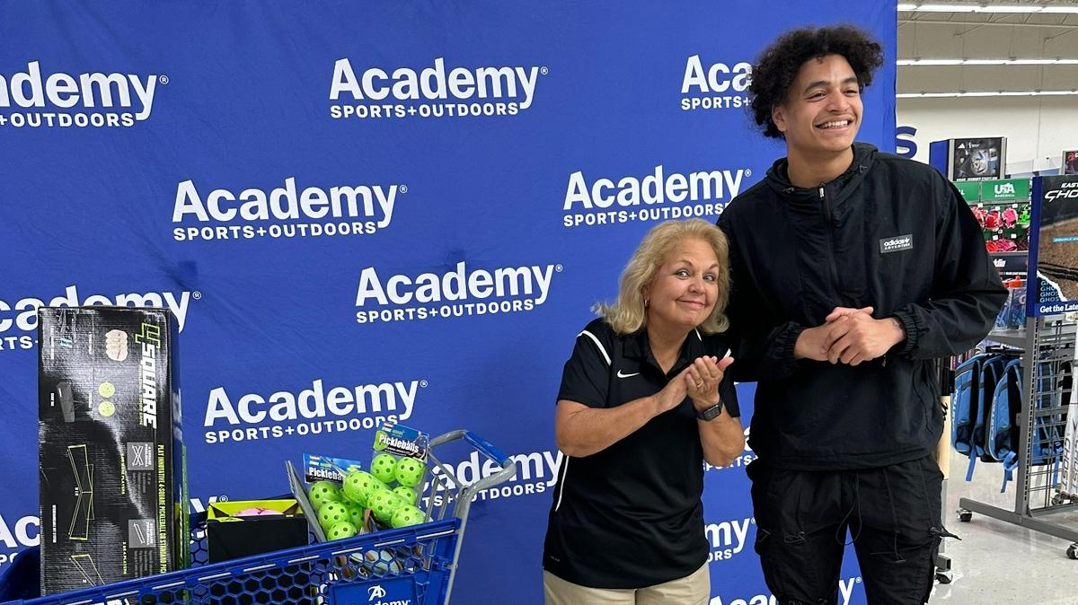 Former Dutch Fork High and University of Tennessee star football player Jalin Hyatt, right, surprises teachers with a shopping spree at Academy Sports.