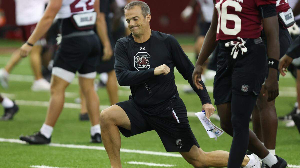 South Carolina head coach Shane Beamer stretches with his team during practice in Columbia on Friday, August 11, 2023.