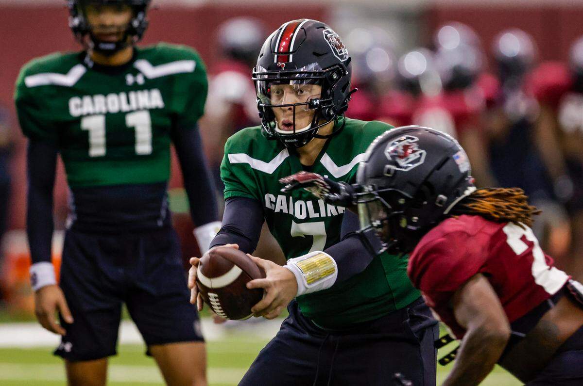 USC’s Spencer Rattler hands off to JuJu McDowell while preparing for theTaxSlayer Gator Bowl at the Jerri and Steve Spurrier indoor practice facility on Thursday Dec. 15, 2022.