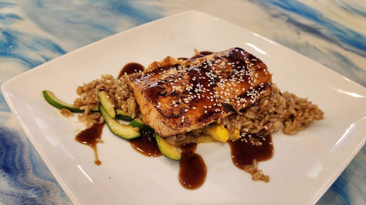 The grilled salmon with sauteed rice at The Epicurean Table at 9661 Garners Ferry Road in Hopkins.