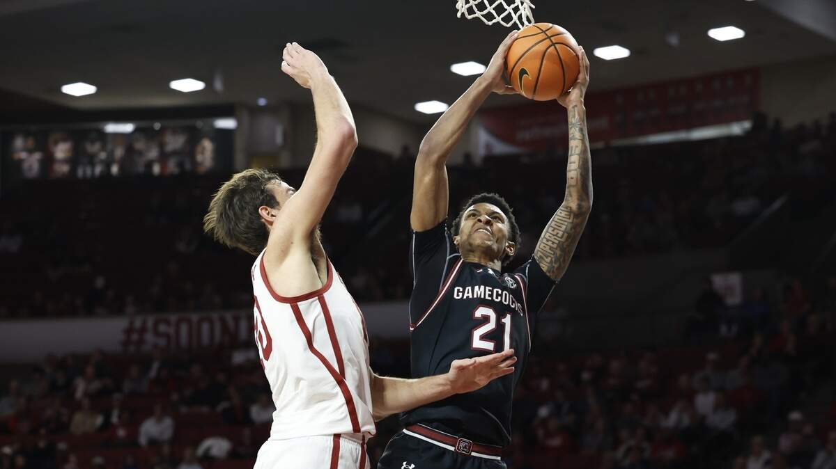 South Carolina Gamecocks guard Arden Conyers (21) shoots as Oklahoma Sooners forward Sam Godwin (10) defends during the first half at Lloyd Noble Center.
