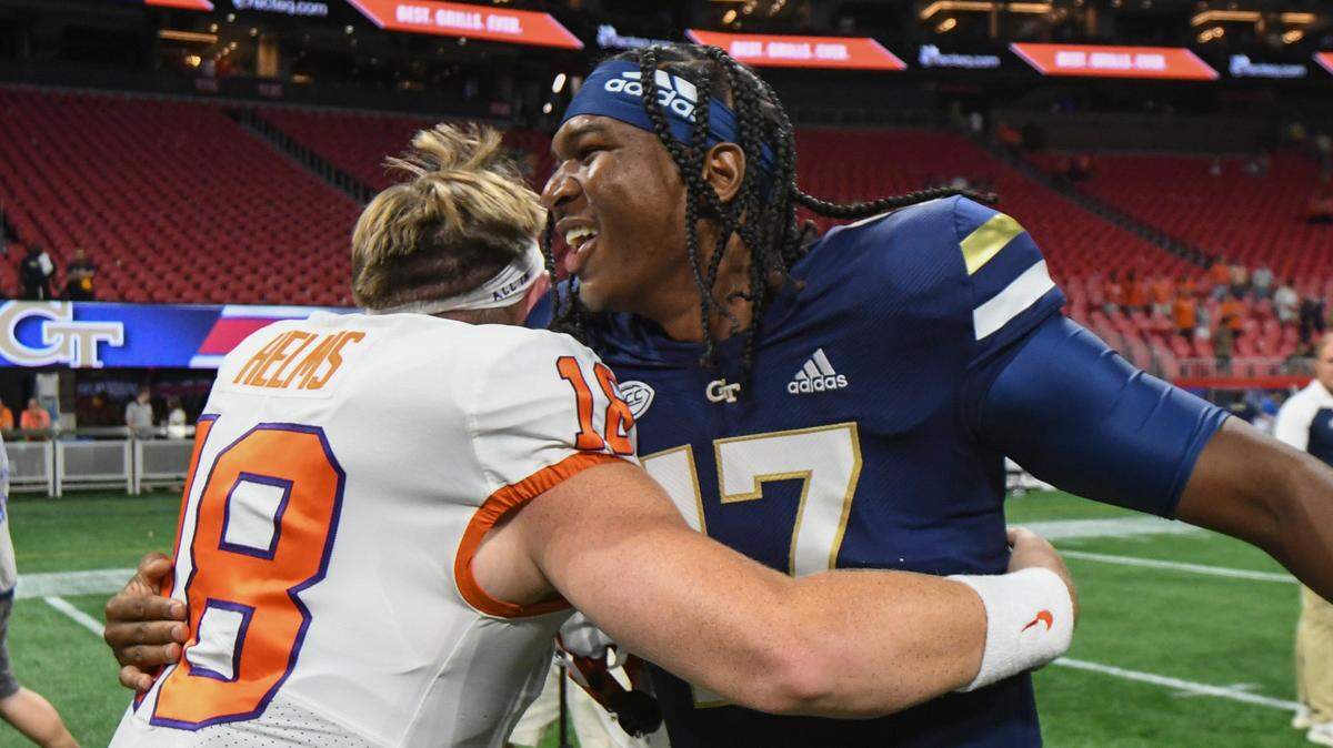 Clemson quarterback Hunter Helms, left, embraced Georgia Tech quarterback Taisun Phommachanh, right, after a NCAA college football game Monday, Sept. 5, 2022, in Atlanta. (AP Photo/Hakim Wright Sr.)