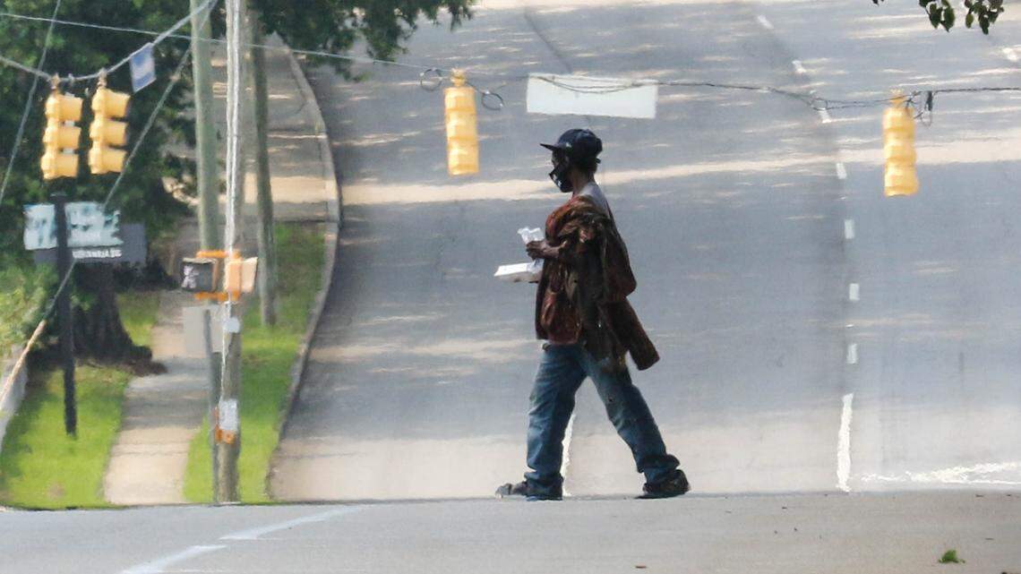 Groups of people walk to Oliver gospel Mission in downtown Columbia for a meal.