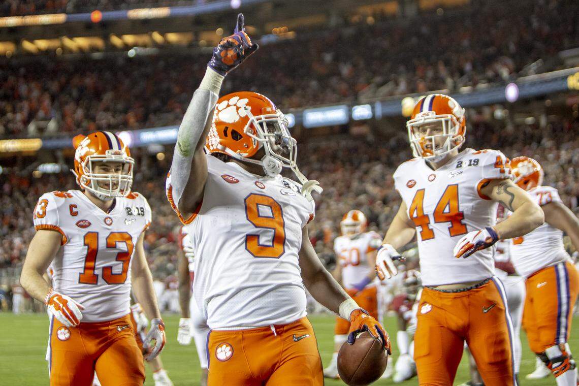 Clemson Tigers running back Travis Etienne (9) celebrates with Clemson Tigers wide receiver Hunter Renfrow (13) and Clemson Tigers tight end Garrett Williams (44) after scoring a touchdown during the College Football Playoff National Championship against Alabama at Levi’s Stadium on Monday Jan. 7, 2019, in Santa Clara, CA.