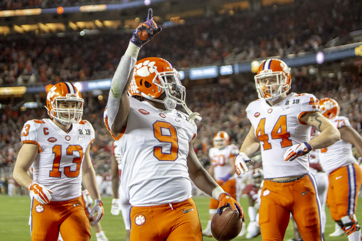 Clemson Tigers running back Travis Etienne (9) celebrates with Clemson Tigers wide receiver Hunter Renfrow (13) and Clemson Tigers tight end Garrett Williams (44) after scoring a touchdown during the College Football Playoff National Championship against Alabama at Levi’s Stadium on Monday Jan. 7, 2019, in Santa Clara, CA.