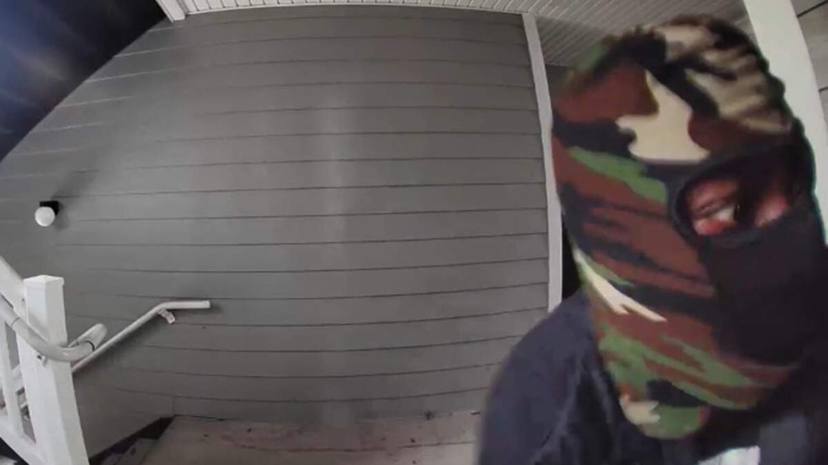 Surveillance footage screen grab of a person wanted for their involvement in a shooting.