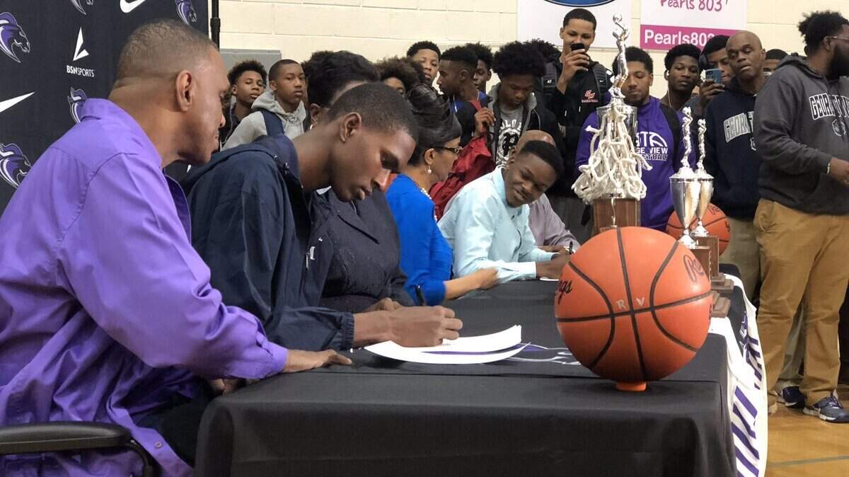 Ridge View center Malcolm Wilson signs to play basketball at Georgetown on Nov. 14, 2018.