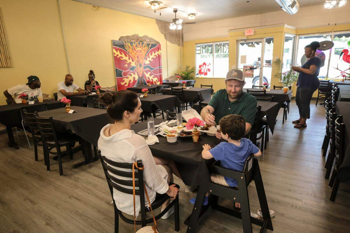 Alaleh Torkjazi, Robert Pettis and Kian, 2, dine at Trini Lime Caribbean Cafe in Cayce on Saturday, Aug. 3, 2024