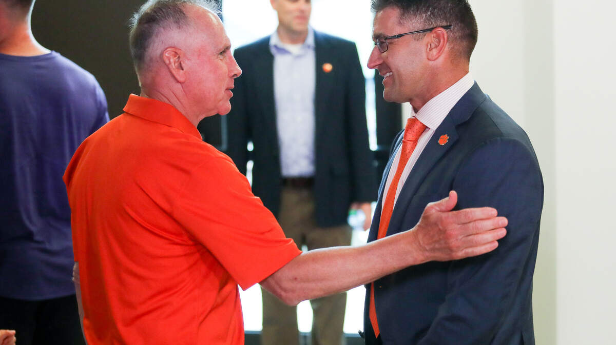 Clemson head baseball coach Erik Bakich speaks with former Clemson head baseball coach Jack Leggett during the introductory press conference at Doug Kingsmore Stadium, June 16th, 2022.