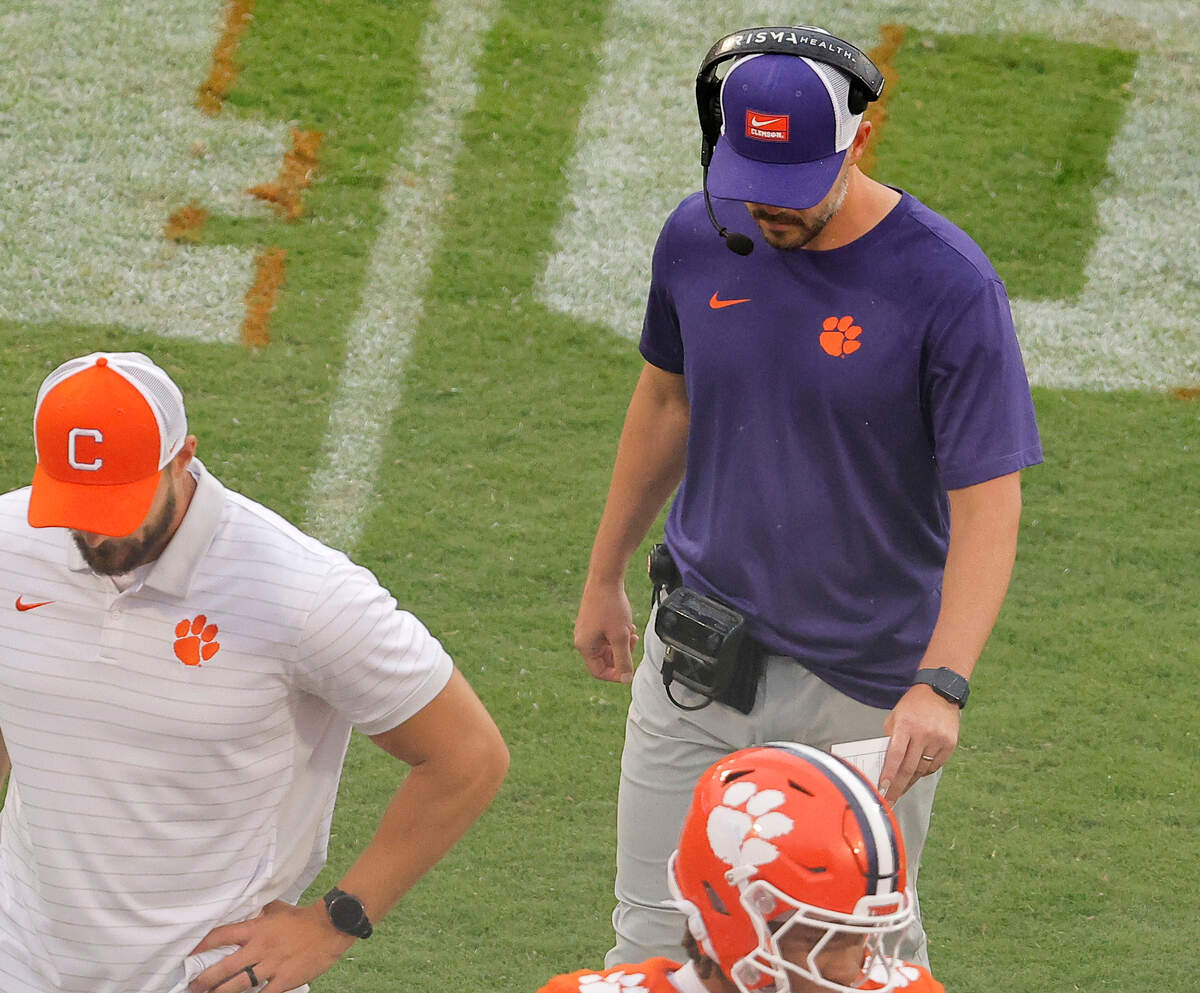 Clemson offensive coordinator Garrett Riley, right, walks off the field after talking to the team during second-half action of the Syracuse game in Clemson, S.C on Saturday, Sept. 20, 2025.