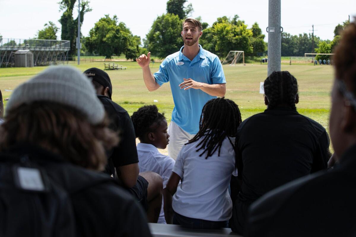 Jay Urich introduces a nutrition coach at his football camp, Original Design.