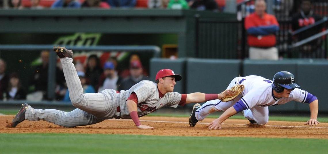 South Carolina 1st baseman LB Dantzler (20) tags Furman shortstop Hunter Burton (1) after catching him in a run down between 1st and 2nd at Fluor Field at the West End.