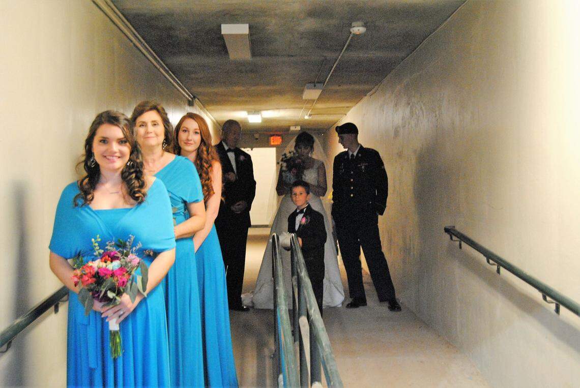 Her bridesmaids smile as Tonya Mullins Flake prepares for her wedding which was arranged by a USC class.
