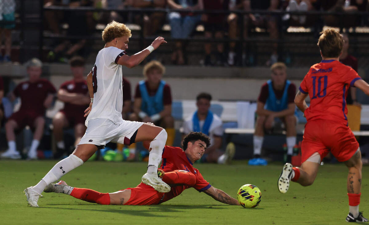 South Carolina midfielder Jonah Bigger (13) dribbled past Clemson midfielder Nathan Richmond (25) during the Gamecocks’ game against Tigers in Columbia on Friday, August 30, 2024.