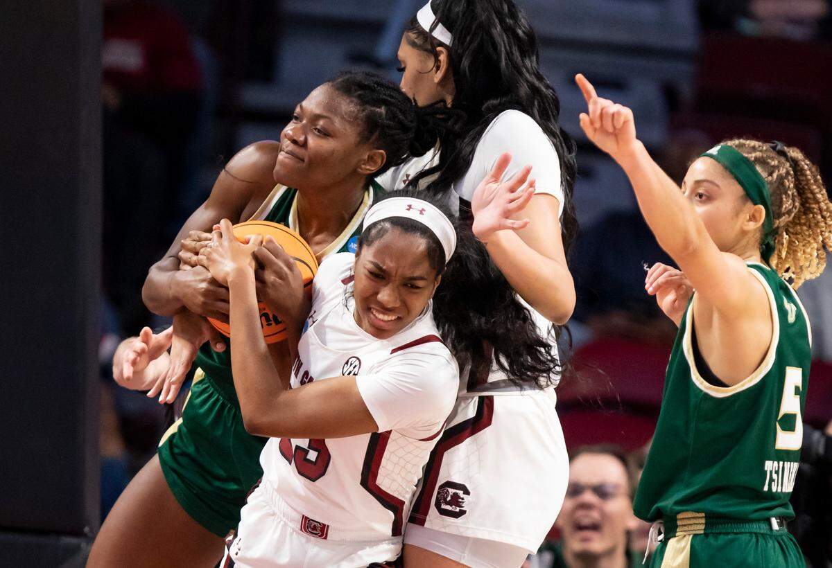 South Carolina guard Bree Hall (23) battles for a loose ball with South Florida forward Dulcy Fankam Mendjiadeu (32) during Sunday’s NCAA Tournament game at Colonial Life Arena in Columbia on Sunday, March 19, 2023.