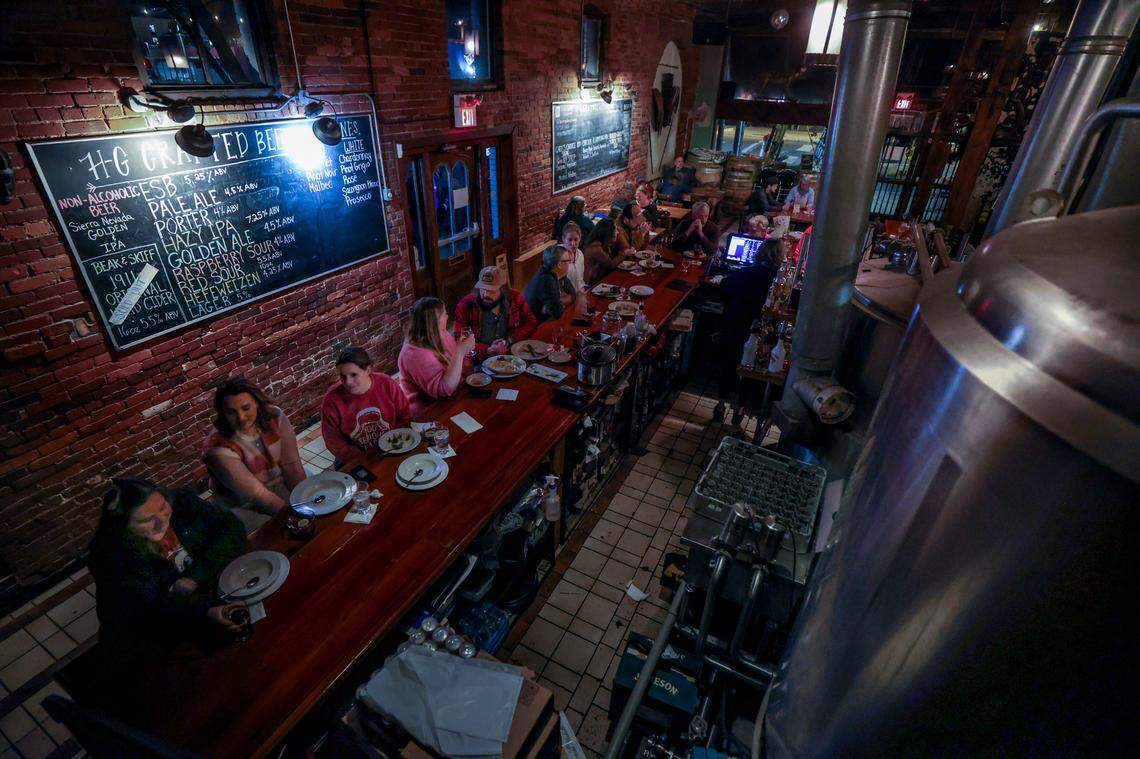 Patrons enjoy dinner and drinks at Hunter Gatherer in Columbia on Thursday Dec. 12, 2024. Hunter Gatherer opened in 1995 as Columbia’s first microbrewery. It will close at the end of December.