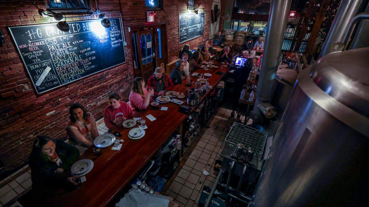 Patrons enjoy dinner and drinks at Hunter Gatherer in Columbia on Thursday Dec. 12, 2024. Hunter Gatherer opened in 1995 as Columbia’s first microbrewery. It will close at the end of December.