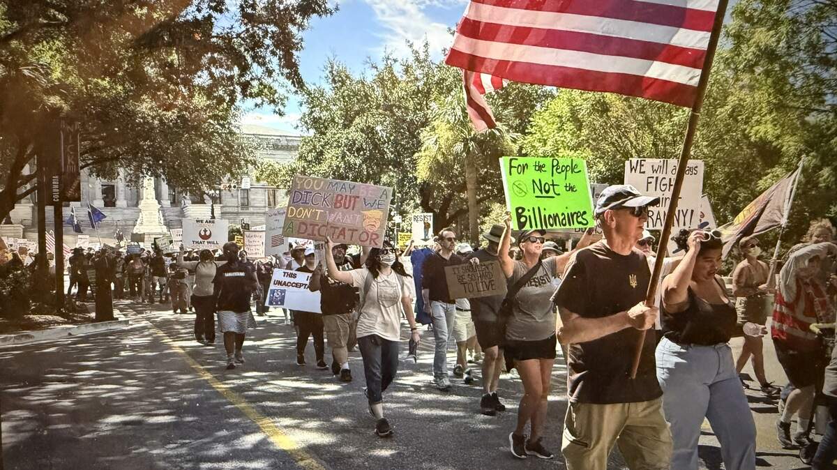 After a Labor Day rally at the S.C. State House, people marched to the downtown U.S. Post Office to show support for postal workers. 