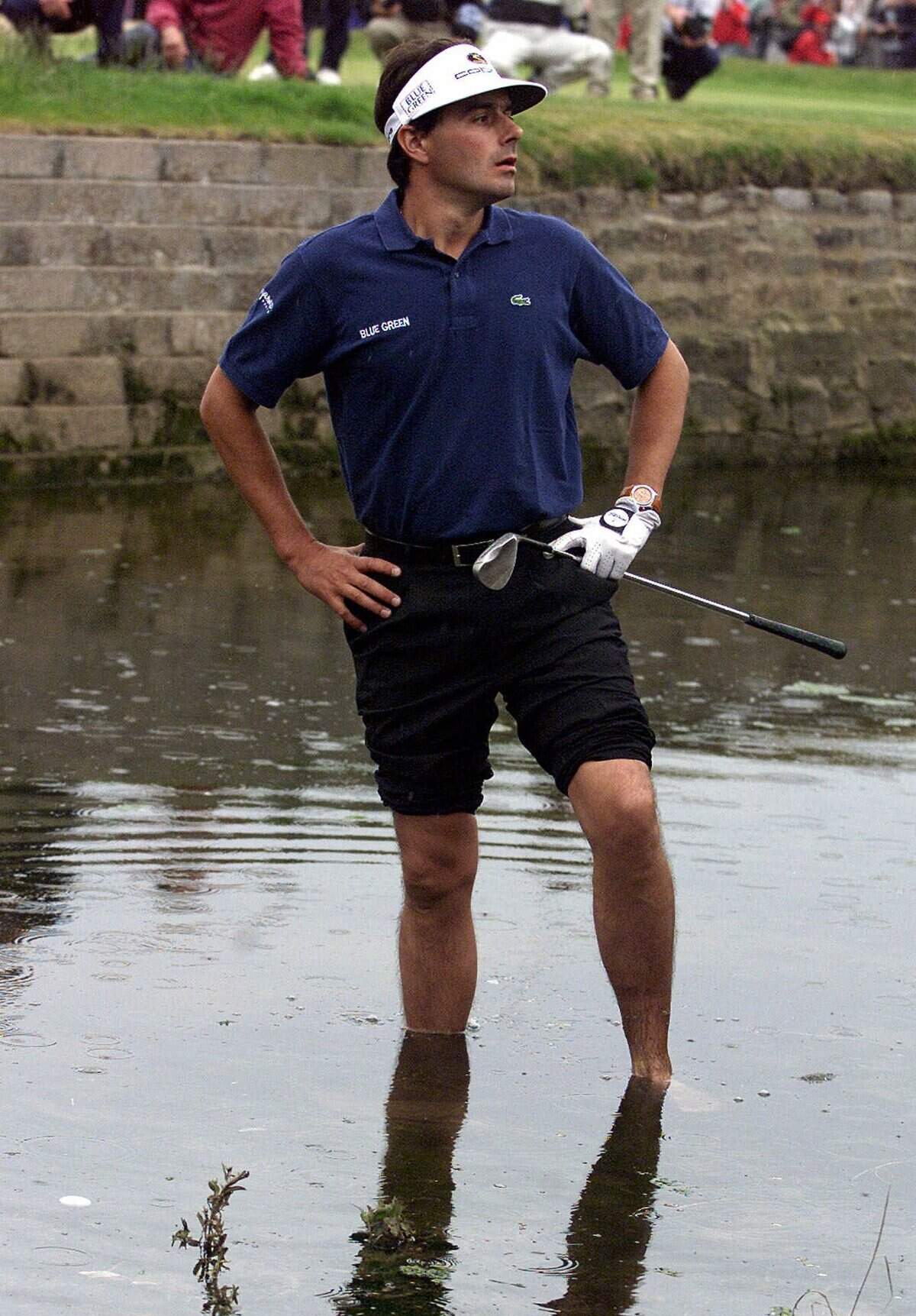 From Sunday, July 18, 1999: France's Jean van de Velde stands in "the burn" that crosses the 18th fairway to see if his ball was playable during the final round of the 128th Open Golf Championship at Carnoustie, Scotland.