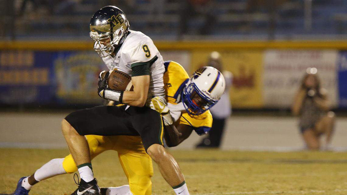 North Myrtle Beach defensive back Derion Conyers (1) tackles Myrtle Beach wide out Luke Doty (9)