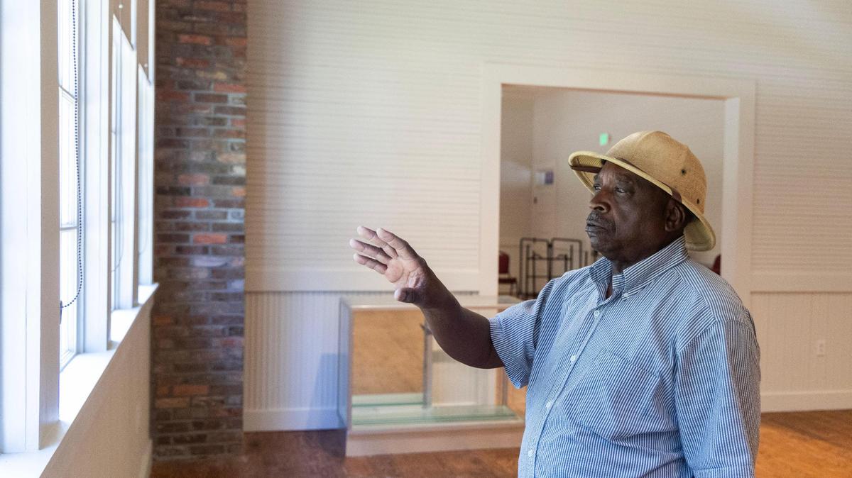 Ralph James shows facilities at the restored Williams Memorial Rosenwald School in St. George, South Carolina. The renovated school includes meeting spaces, a museum and a theater clad in boards from all around the school.
