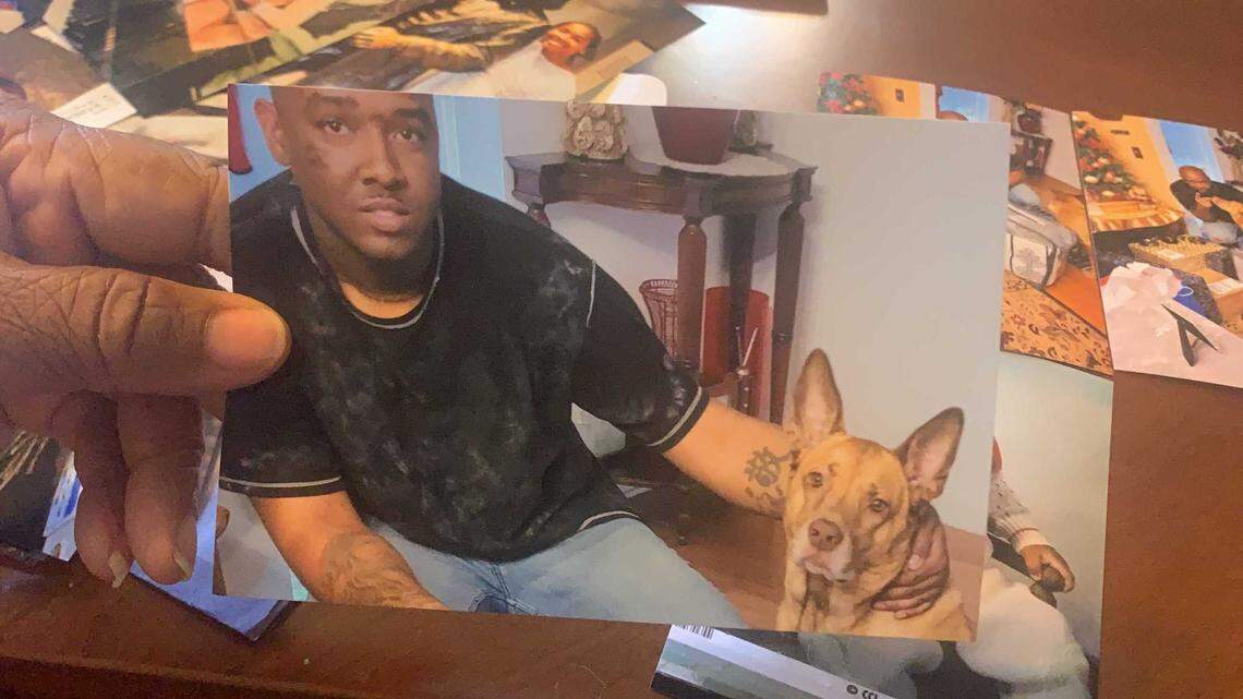 Amy Sutherland holds a photo of her son Jamal Sutherland on Christmas Day 2020 with his dog, Duke. “That dog was his life,” she said, flipping through photos. After her son died in the Charleston County jail on Jan. 5, 2021, Amy Sutherland said Duke would wait for him on the steps and cry.