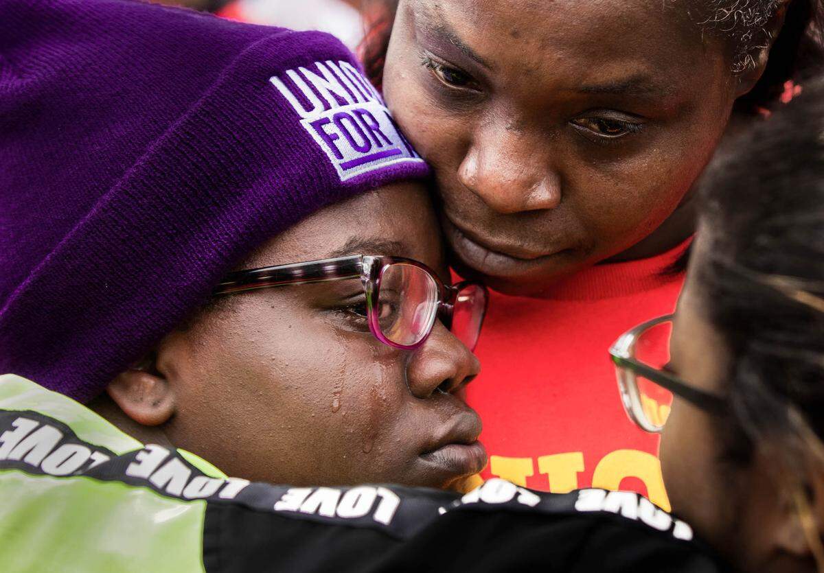 De’Aysa Davis is embraced by fellow striking workers during a Fight for Fifteen march in Charleston, South Carolina on Monday, February 24, 2020. Davis, activists and workers were joined by presidential primary candidate and former South Bend, Indiana Mayor Pete Buttigieg.
