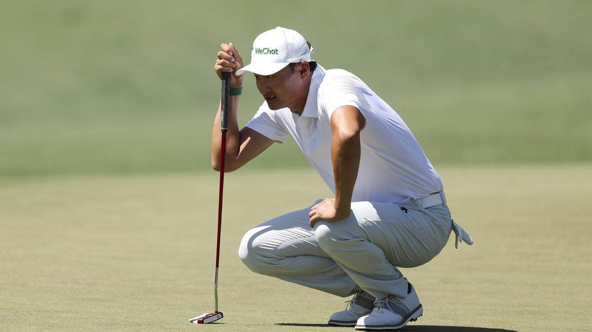 Haotong Li of China lines up a putt on the second green during the third round of the 2026 Masters Tournament at Augusta National Golf Club on April 11, 2026.