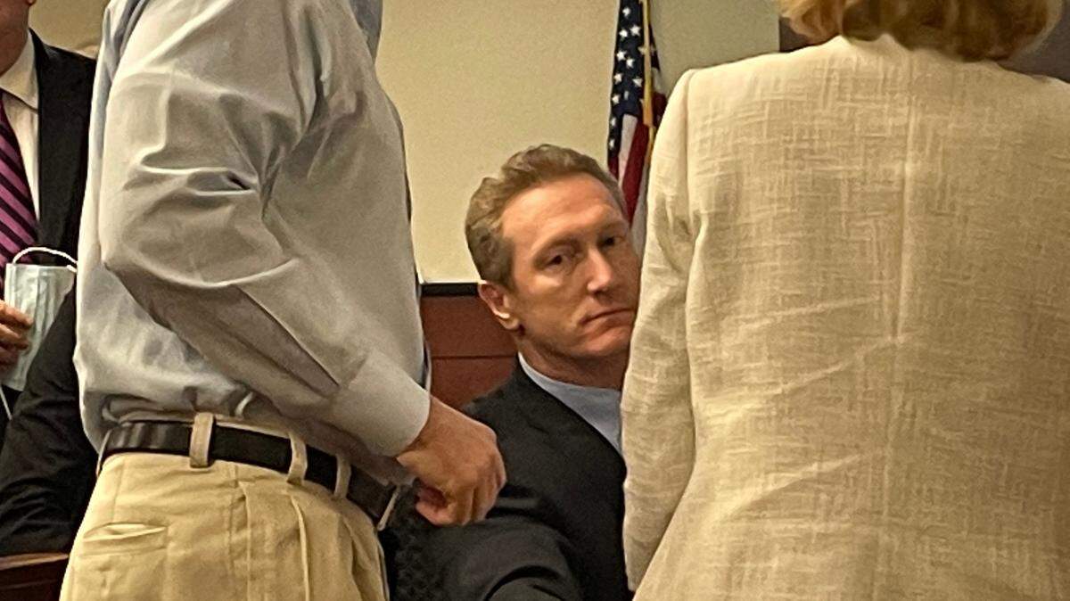 Adam Lazzarini, a former Lexington Medical Center surgeon, sits with his lawyers with family nearby during his trial at the Lexington County court house. He was charged with the fatal shooting of William Player Holland.