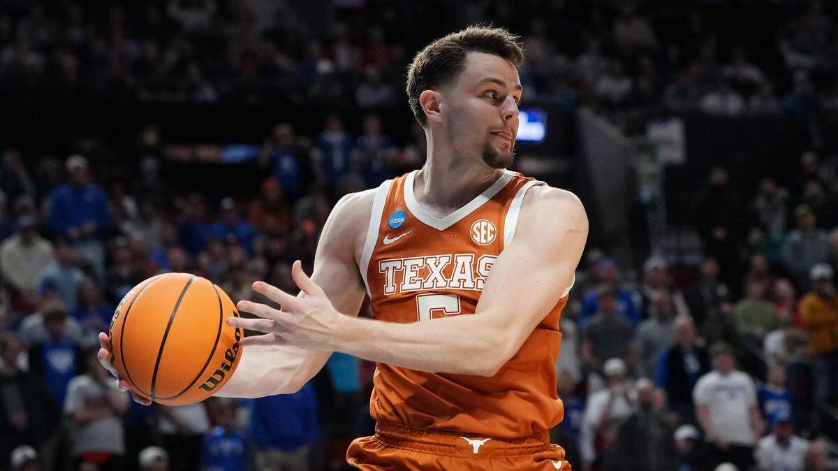 Camden Heide of the Texas Longhorns chases after a loose ball against the BYU Cougars in the first round of the 2026 NCAA Men's Basketball Tournament at Moda Center on March 19, 2026 in Portland, Oregon.
