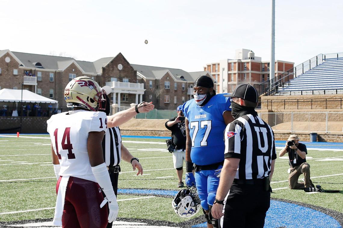 Barton offensive lineman Ray Miller (77) and Erskine linebacker Brandon Lane (14) watch the coin toss before the game Saturday.