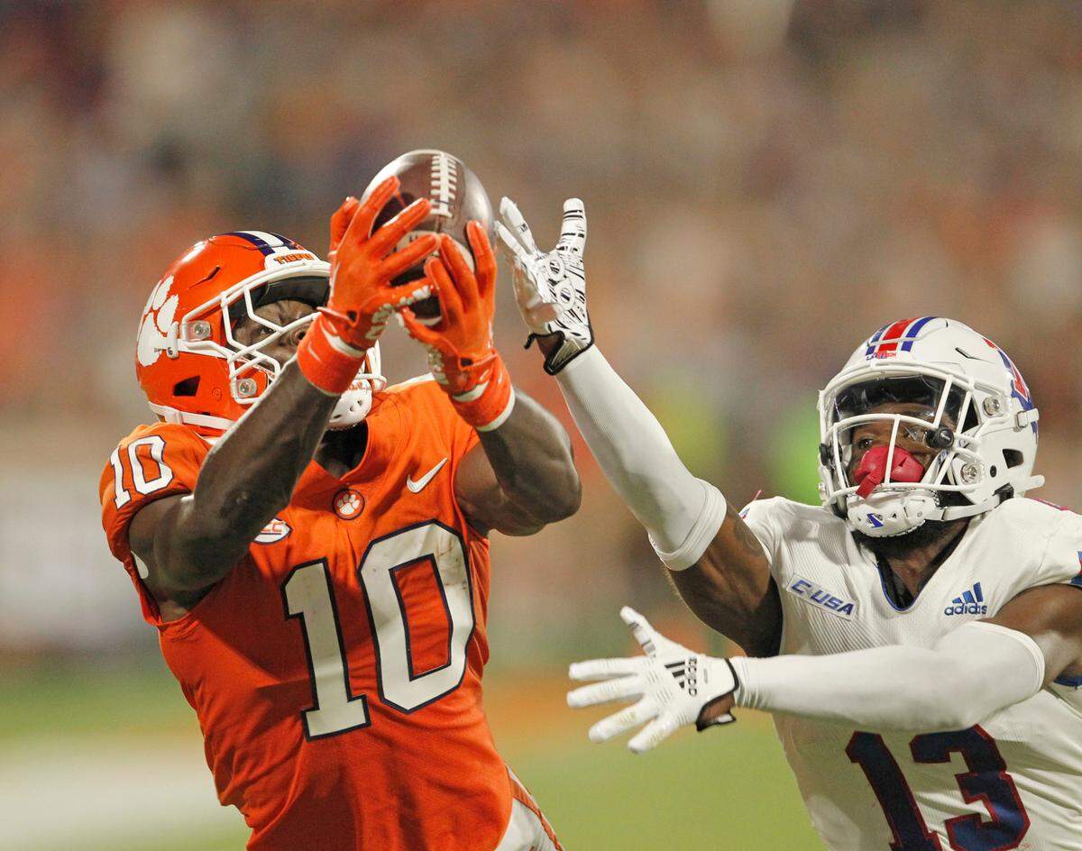 Clemson wide receiver Joseph Ngata (10) hangs on to a catch in front of Louisiana Tech defensive back Myles Brooks (13) during first-quarter action in Clemson, S.C. on Saturday, Sept. 17, 2022.