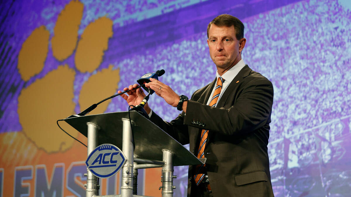 Clemson head coach Dabo Swinney adjusts the microphone at the NCAA college football Atlantic Coast Conference Media Days in Charlotte, N.C., Wednesday, July 20, 2022. (AP Photo/Nell Redmond)