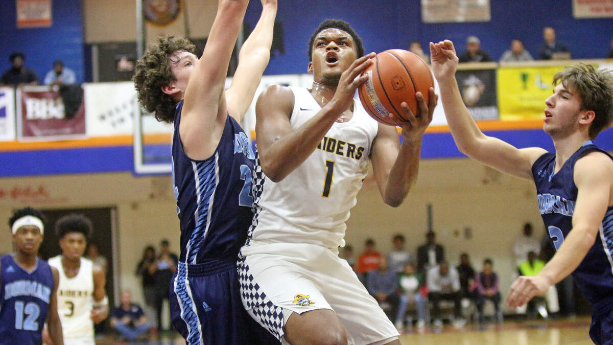 Keenan’s Dillon Jones drives on Dorman’s PJ Hall on Friday at the Chick-fil-A Classic.