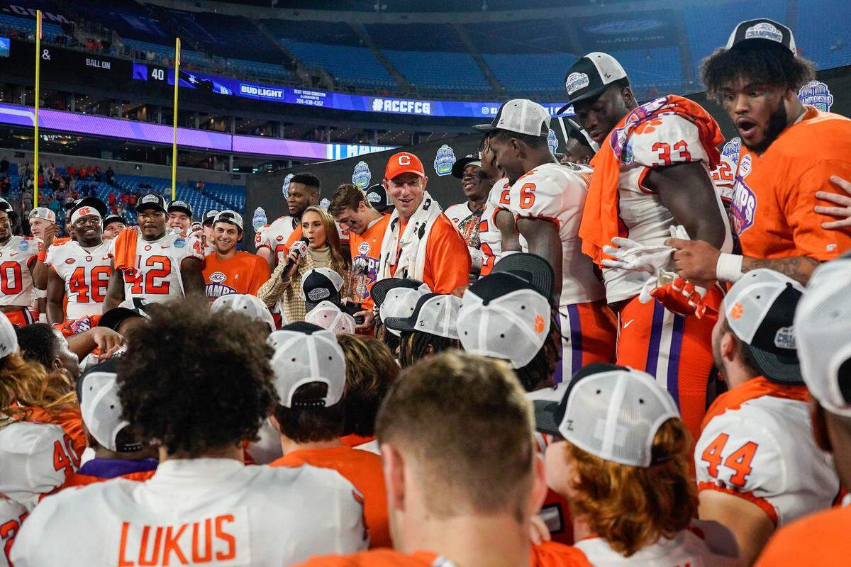 Dec 3, 2022; Charlotte, North Carolina, USA; Clemson Tigers head coach Dabo Swinney is interviewed alongside his team on the stage during the victory celebration after the win over North Carolina Tar Heels at Bank of America Stadium. Mandatory Credit: Jim Dedmon-USA TODAY Sports