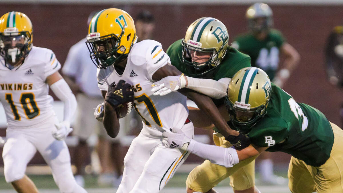 Spring Valley Vikings Deshun Jordan (17) drags River Bluff Gators defenders.