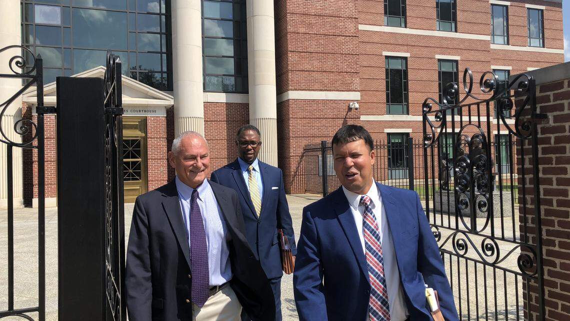 Thomas Brock (left) leaves federal court after a hearing last year with his lawyers, Ed Givens (center) and Ravi Sanyal